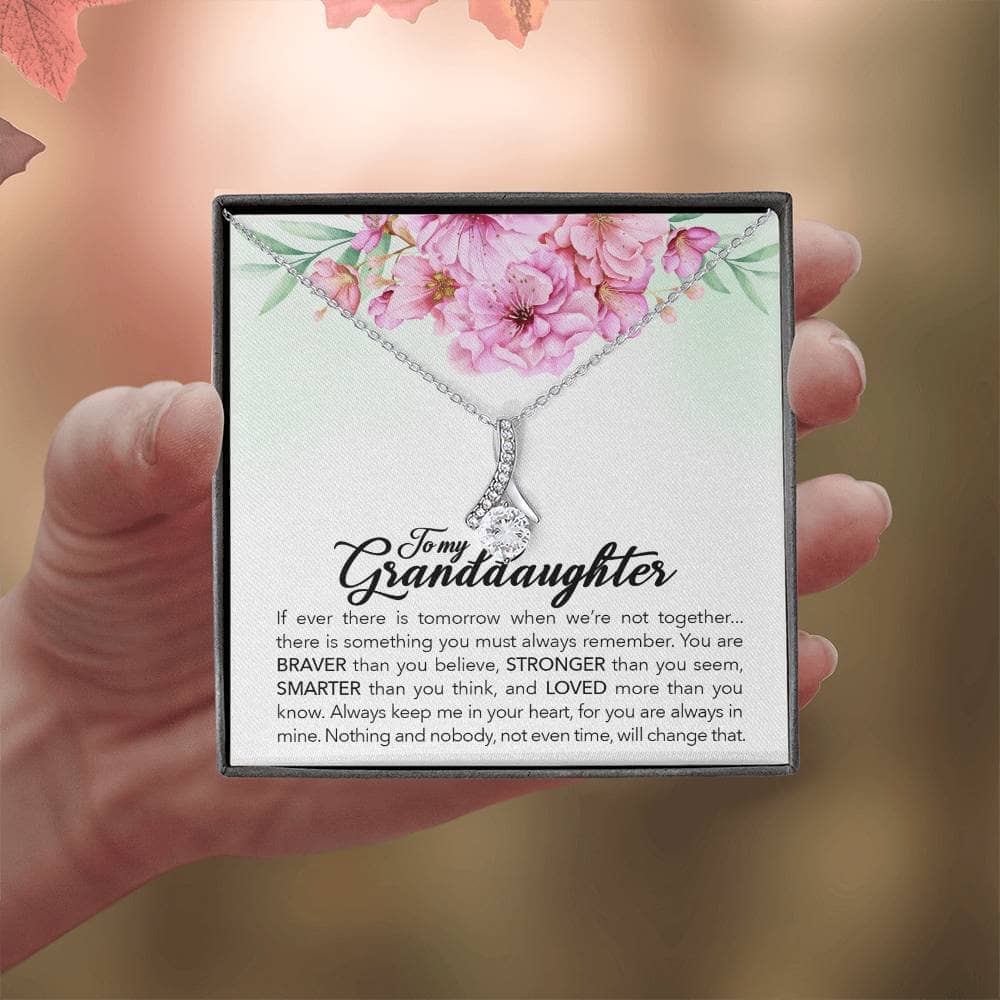Alt text: "A hand holding the 'Always in Your Heart' Personalized Granddaughter Necklace in a box"