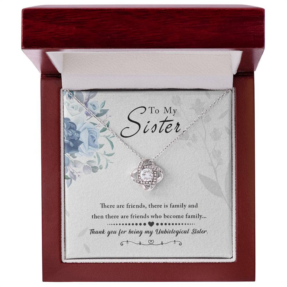 A close-up of the elegantly crafted Personalized Unbiological Sisters Necklace pendant, featuring interlocking hearts and a love knot design.