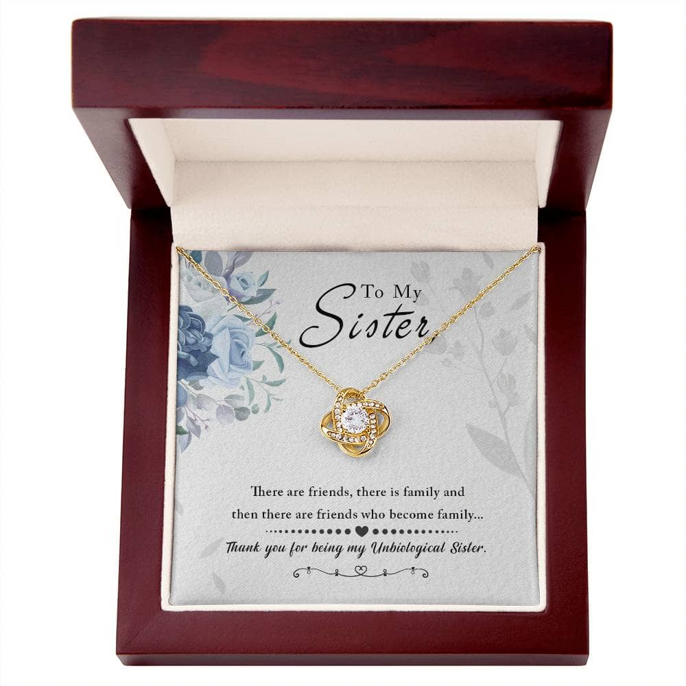 A close-up image of a Custom Love Knot Necklace for Unbiological Sisters. The necklace features an elegantly crafted pendant with interlocking hearts and a love knot design, symbolizing the bond between non-biological sisters. The pendant is adorned with a splendid cushion-cut cubic zirconia. The necklace arrives in a sophisticated mahogany-style box with LED lighting for an unforgettable unboxing experience. Perfect for heartfelt occasions and as a touching gesture of sisterly love.