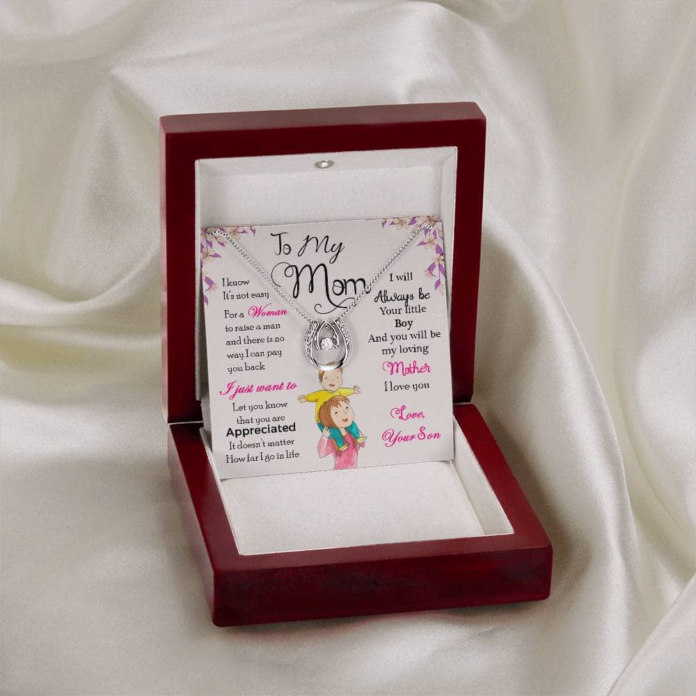 A close-up of a Personalized Mother Necklace in a box, featuring a heart-shaped pendant and adjustable chains.