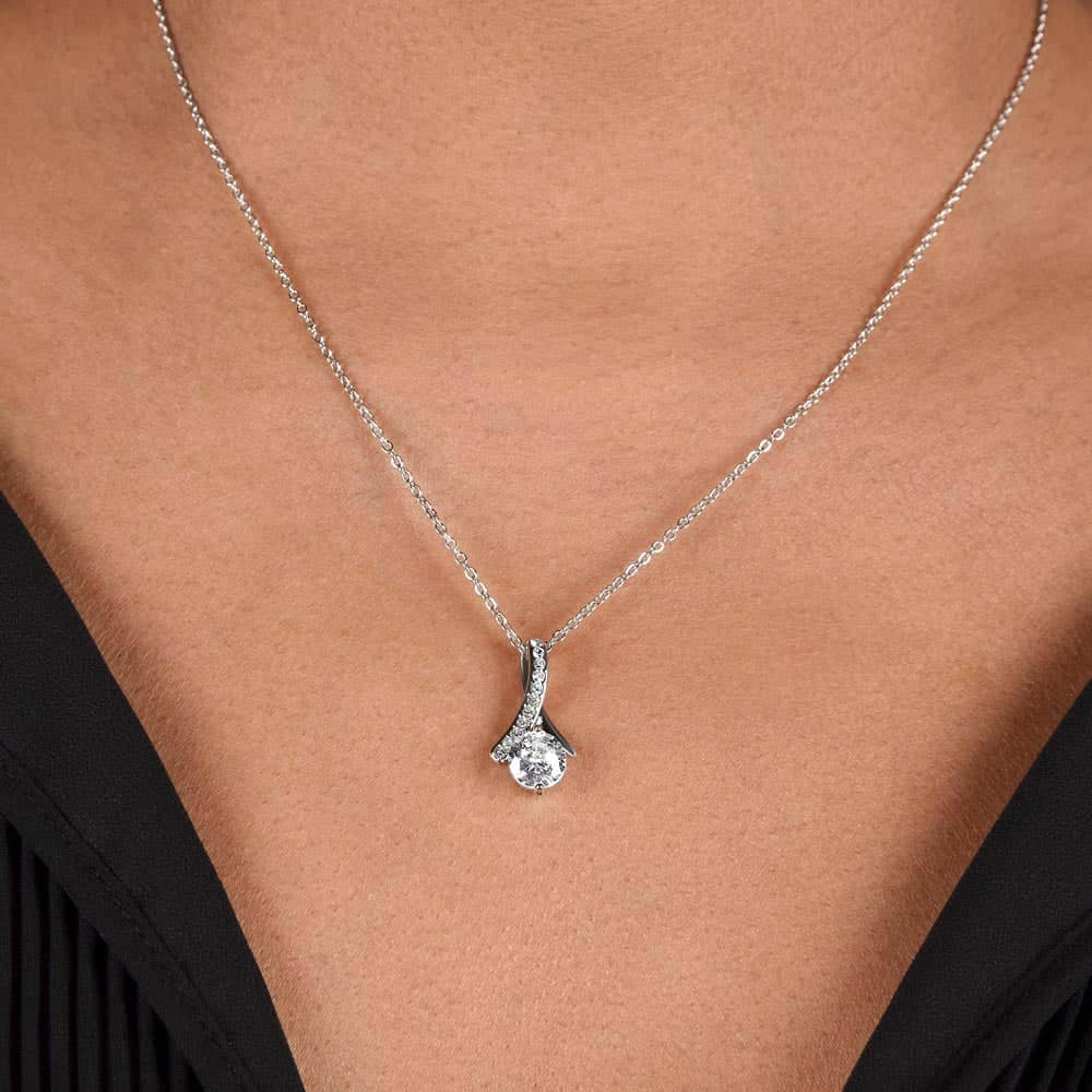 Image alt text: "Close-up of Alluring Beauty necklace with diamond pendant on woman wearing it"
Note: The alt text focuses on the visual elements of the image, describing the necklace and its pendant without mentioning colors or unrelated details. It also incorporates the product title seamlessly into the description.