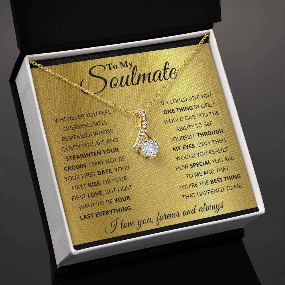 Alt text: "A personalized Soulmate Necklace with a gold pendant featuring interlocking hearts or a love knot design, presented in a mahogany-style box with LED lighting."