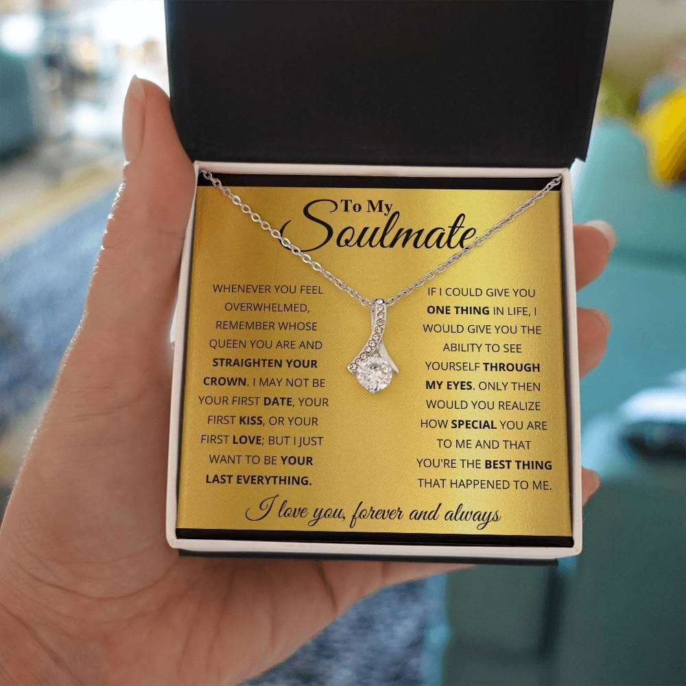 Alt text: "A hand holding the Alluring Beauty Necklace in a luxurious box with LED lighting"