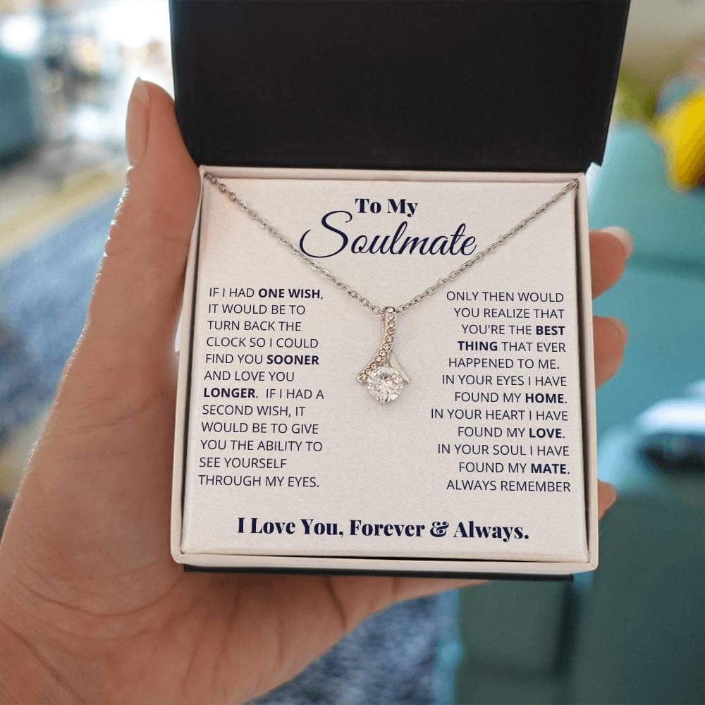 Alt text: "Hand holding Alluring Beauty Necklace in box, symbolizing timeless love and devotion. Radiant cubic zirconia pendant on adjustable chain. LED-lit mahogany-style gift box. Perfect for special occasions and cherished moments."