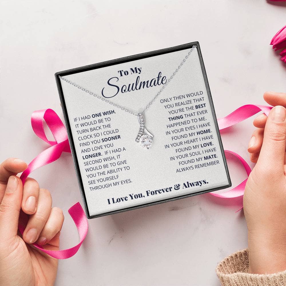Alt text: "Hands holding a box with a personalized Soulmate Necklace, symbolizing enduring love and commitment."