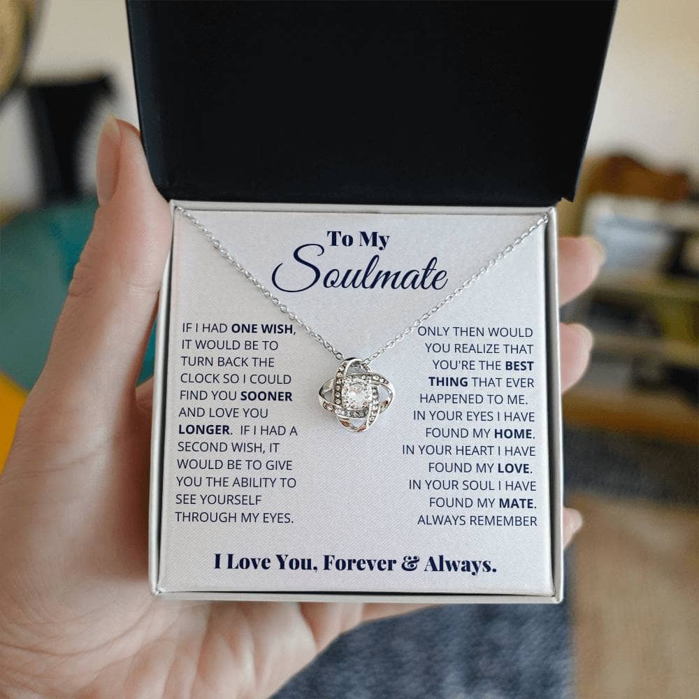 Alt text: "A hand holding the Always & Forever Love Knot Soulmate Necklace in a luxurious box"