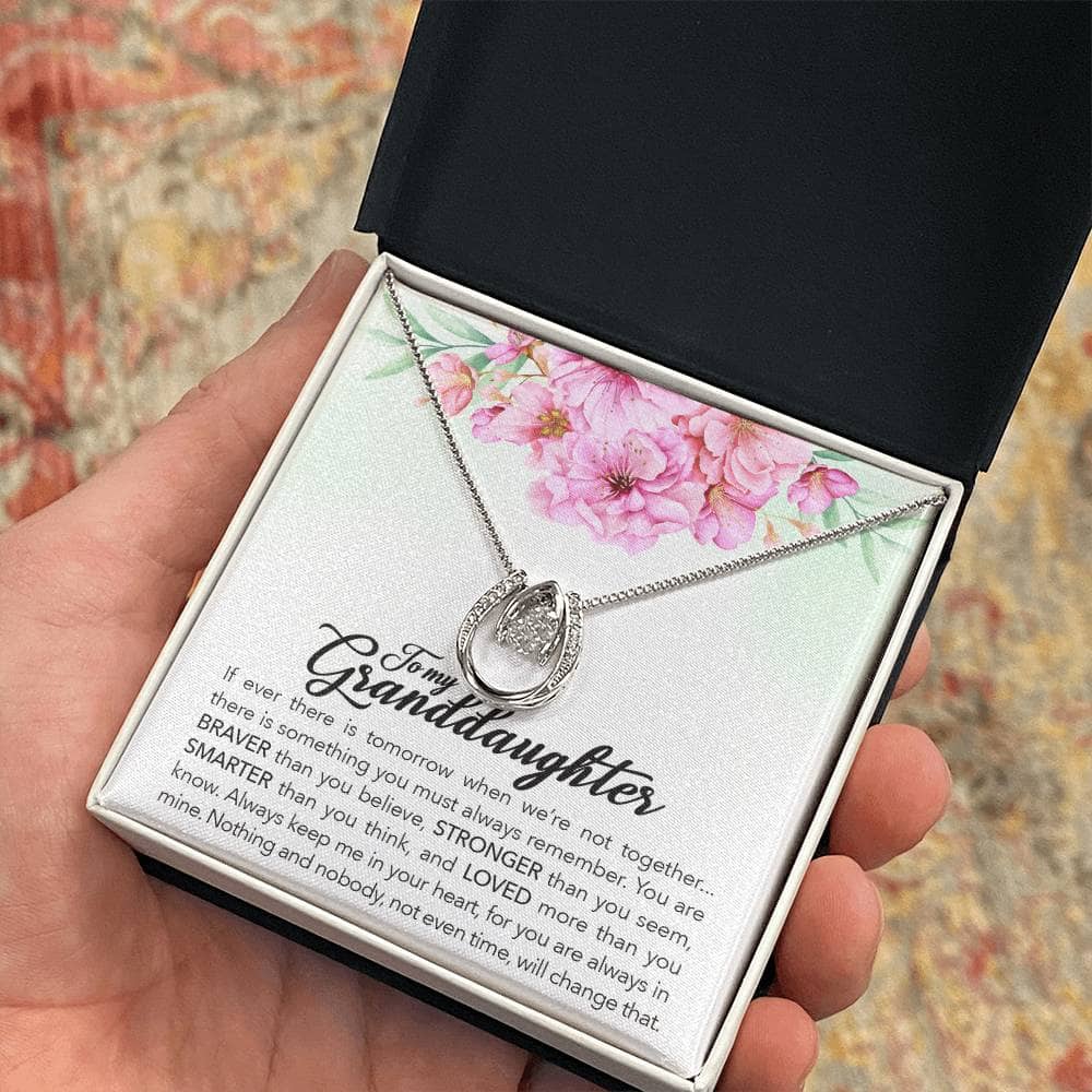 Alt text: "A hand holding the Always in Heart - Personalized Granddaughter Necklace in a box"