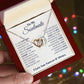 A hand holding the Beloved Soulmate Interlocking Hearts Necklace - Forever & Always, a symbol of enduring love and devotion. Made with 14k white gold and cubic zirconia, this personalized necklace represents the unbreakable bond between soulmates. Perfect for special occasions or everyday wear, it comes in a luxurious mahogany-style box with LED lighting for a magical unboxing experience. Celebrate love with this lasting symbol of partnership.
