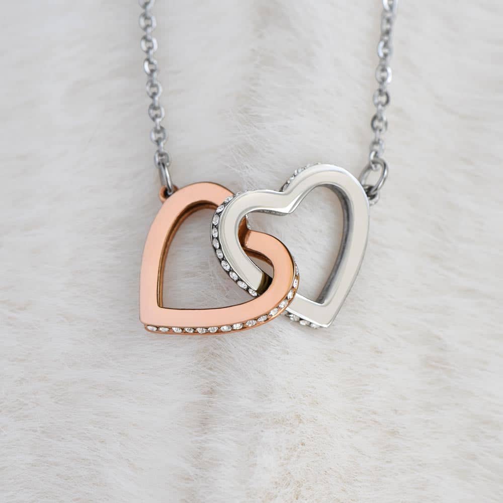 alt: "A personalized necklace with interlocking hearts, symbolizing enduring love and devotion. Made with high-quality materials like 14k white gold and cubic zirconia. Perfect for everyday wear or special occasions. Presented in a luxurious mahogany-style box with LED lighting. A lasting symbol of your unique partnership."