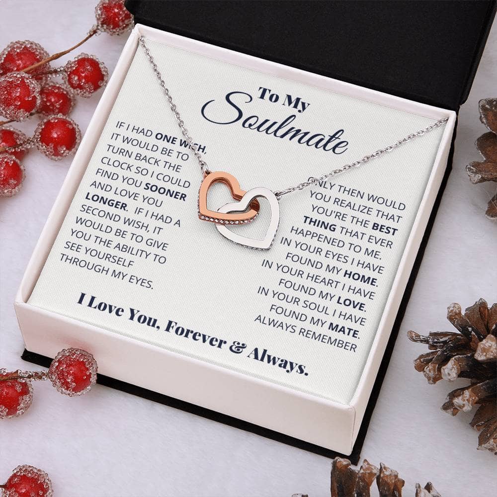 Alt text: "Beloved Soulmate Interlocking Hearts Necklace in a luxurious box with pine cones and berries"