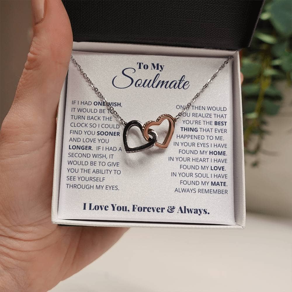 Alt text: "A hand holding a Beloved Soulmate Interlocking Hearts Necklace - Forever & Always, symbolizing enduring love and devotion."