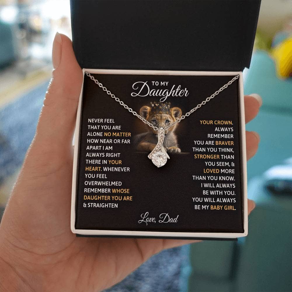 Alt text: "A hand holding a personalized daughter necklace with a tiger pendant, symbolizing the cherished bond between parents and daughters."