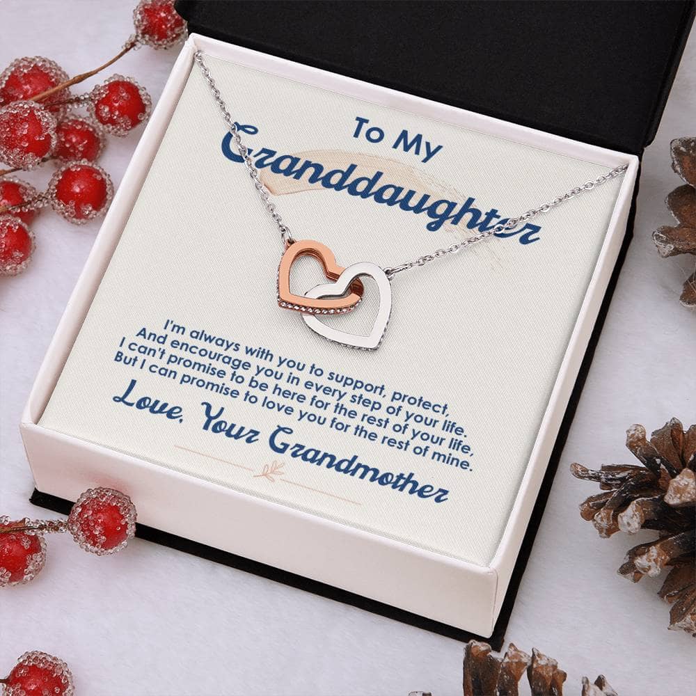 A necklace in a box with pine cones and berries, symbolizing the cherished bond between a grandmother and her granddaughter.