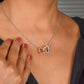 A woman wearing a personalized granddaughter necklace with a heart-shaped pendant, symbolizing the grandparent-granddaughter bond.