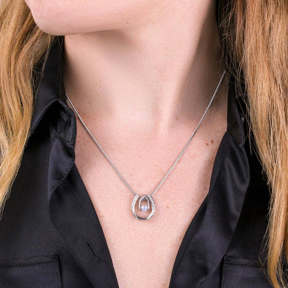 Alt text: "A woman wearing the Cherished Moments Personalized Daughter Necklace, a heart-shaped pendant with a cushion-cut cubic zirconia, symbolizing the bond between parent and daughter."