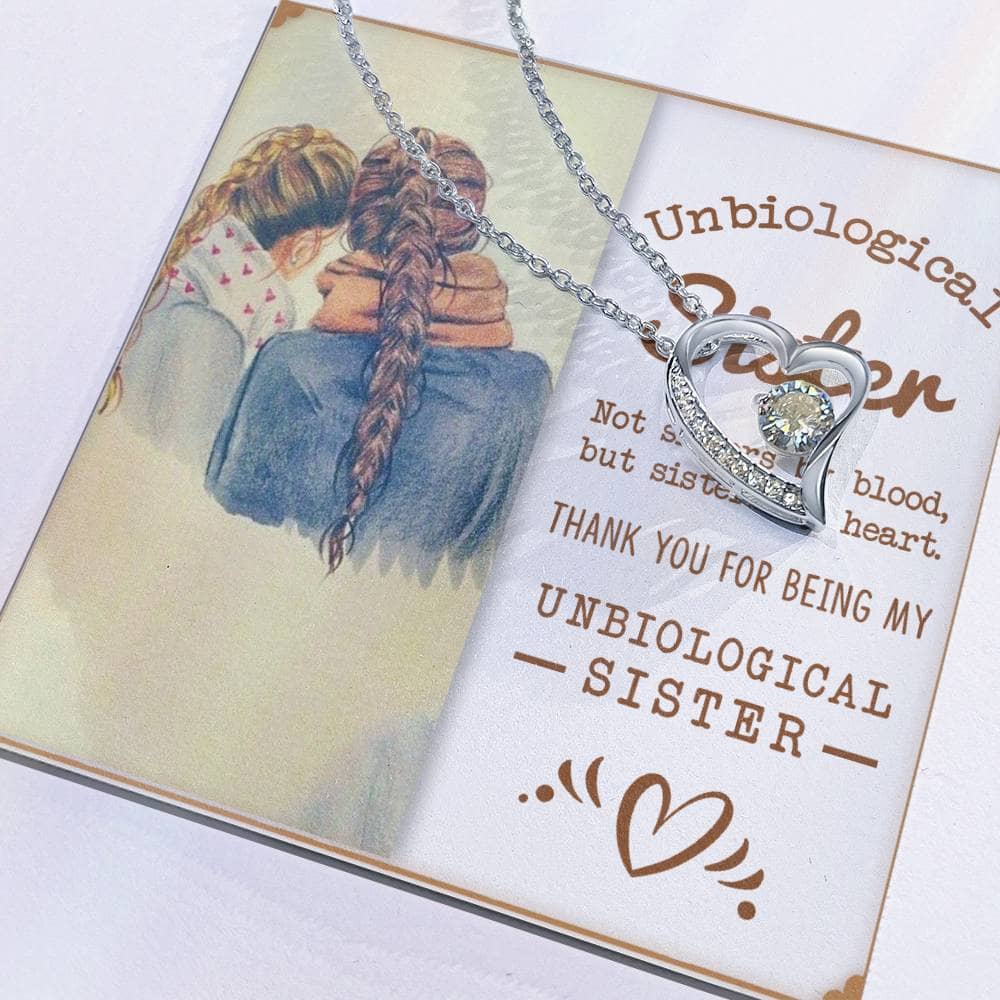 Custom-made Sisters By Heart Cubic Zirconia Necklace on a card. Close-up of intertwined heart-shaped pendant symbolizing unbreakable bonds of sisterhood.