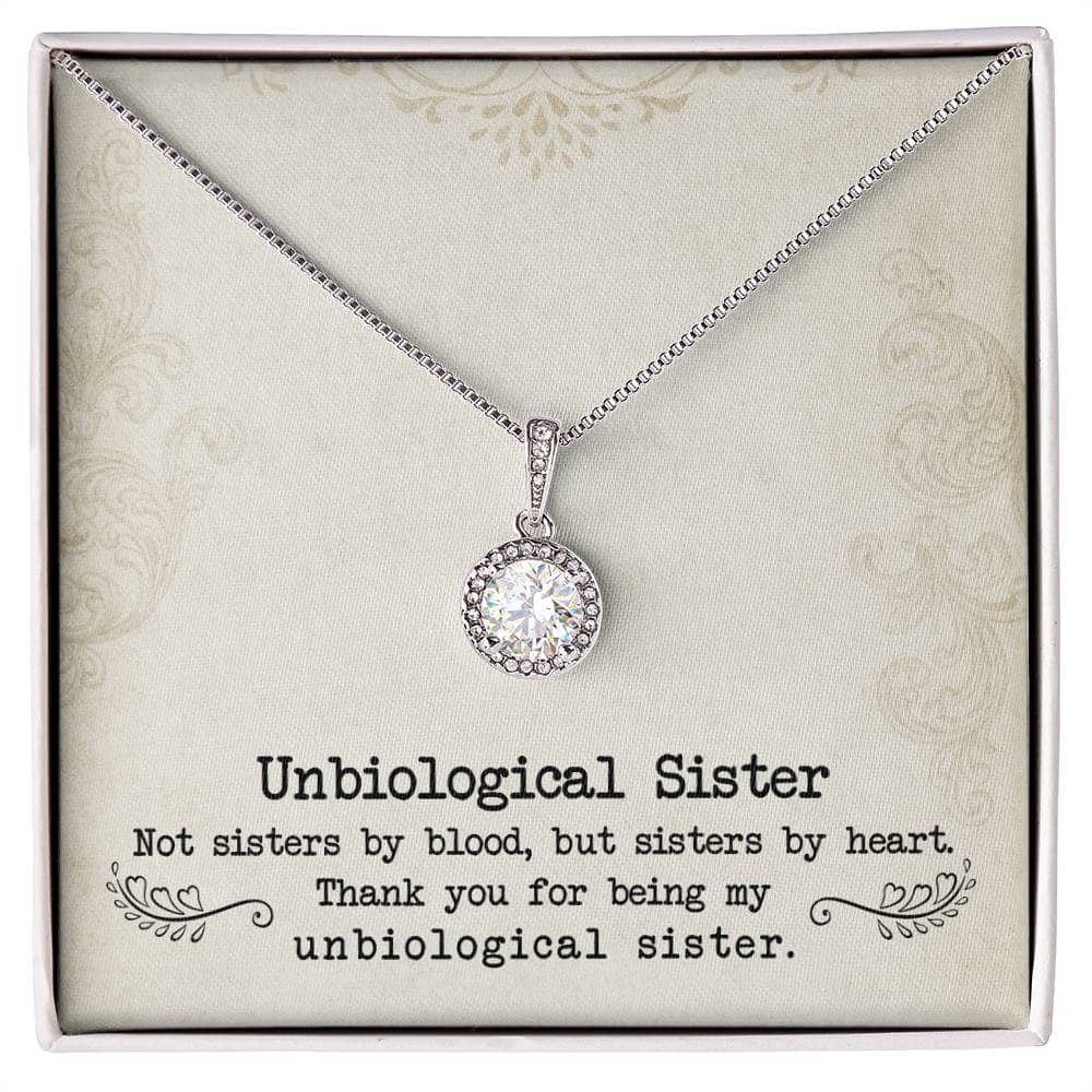 A close-up of a diamond pendant necklace in a box, symbolizing the unbreakable bond between unbiological sisters.