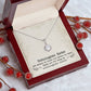 Alt text: "Personalized Unbiological Sisters Necklace in a box with red berries"