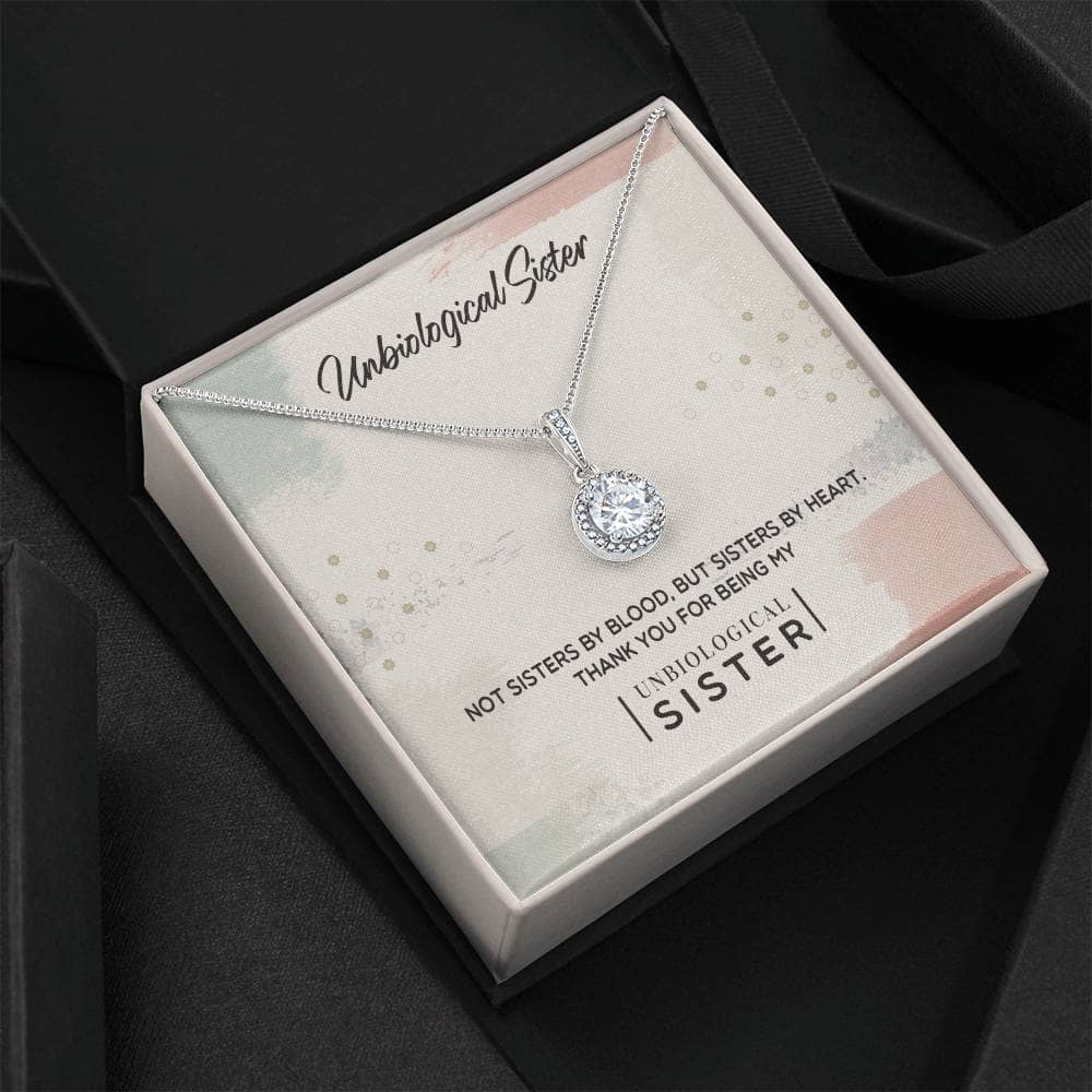 Alt text: "Custom Unbiological Sisters Commemorative Necklace in box with diamond pendant"