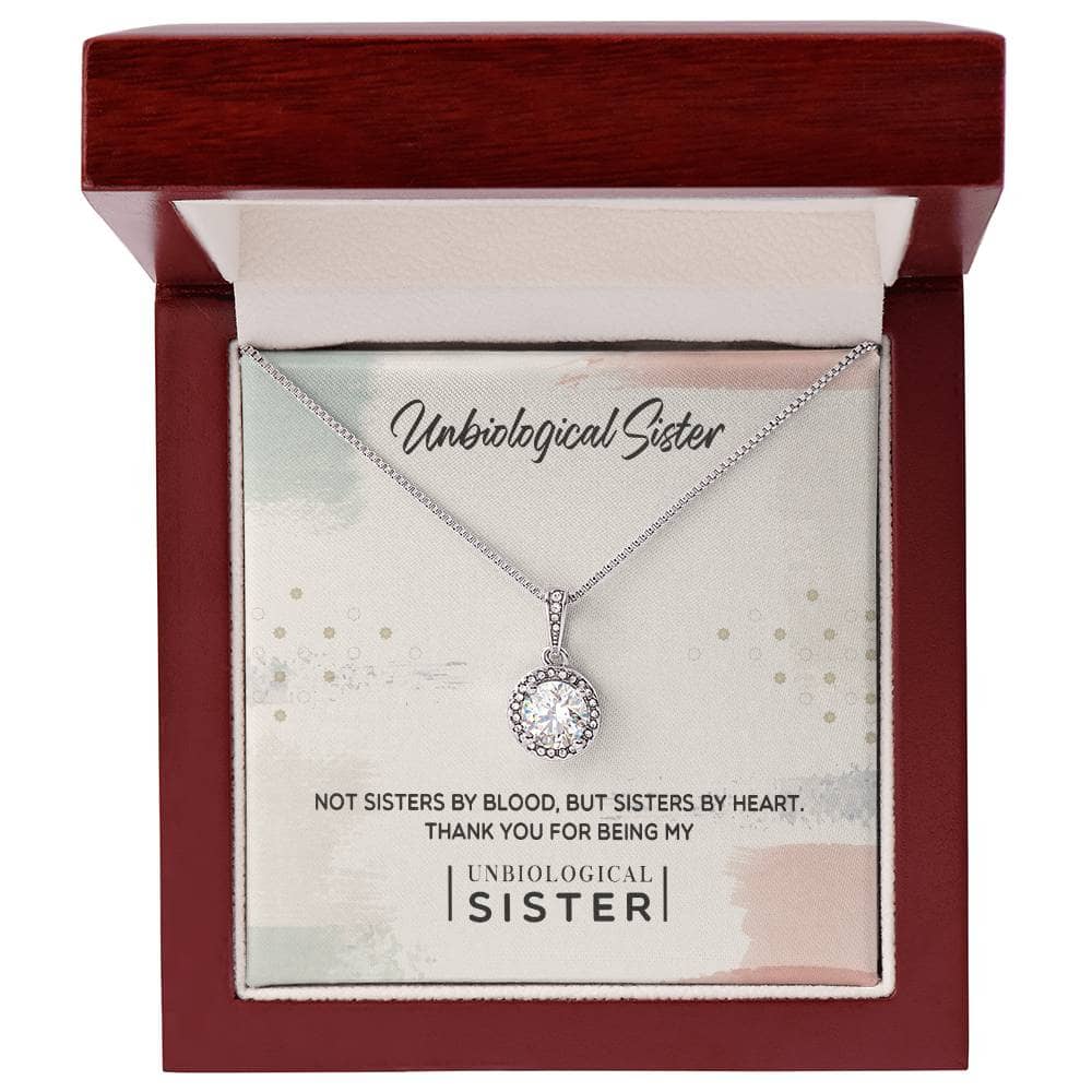 A necklace in a box with a diamond pendant, symbolizing the bond between unbiological sisters. Handcrafted with 14k white gold or 18k gold, adorned with cushion-cut cubic zirconia. Adjustable chain for comfort and versatility. Packaged in a luxurious mahogany-style box with LED lighting. Celebrate sisterhood with this Custom Unbiological Sisters Commemorative Necklace.