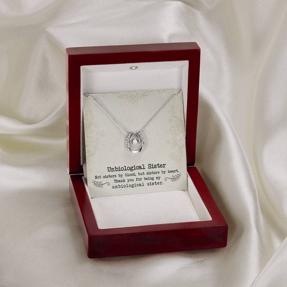 Alt text: "Custom Unbiological Sisters Necklace in box with diamond pendant"