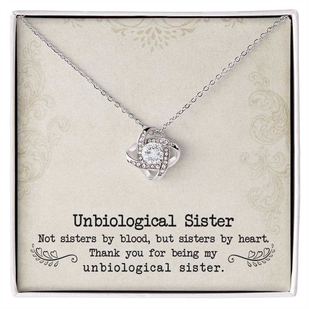 A close-up of the Custom Unbiological Sisters Love Knot Necklace, a necklace in a box.