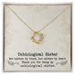 A gold necklace with a diamond pendant in a box, symbolizing the unbreakable bond between unbiological sisters.