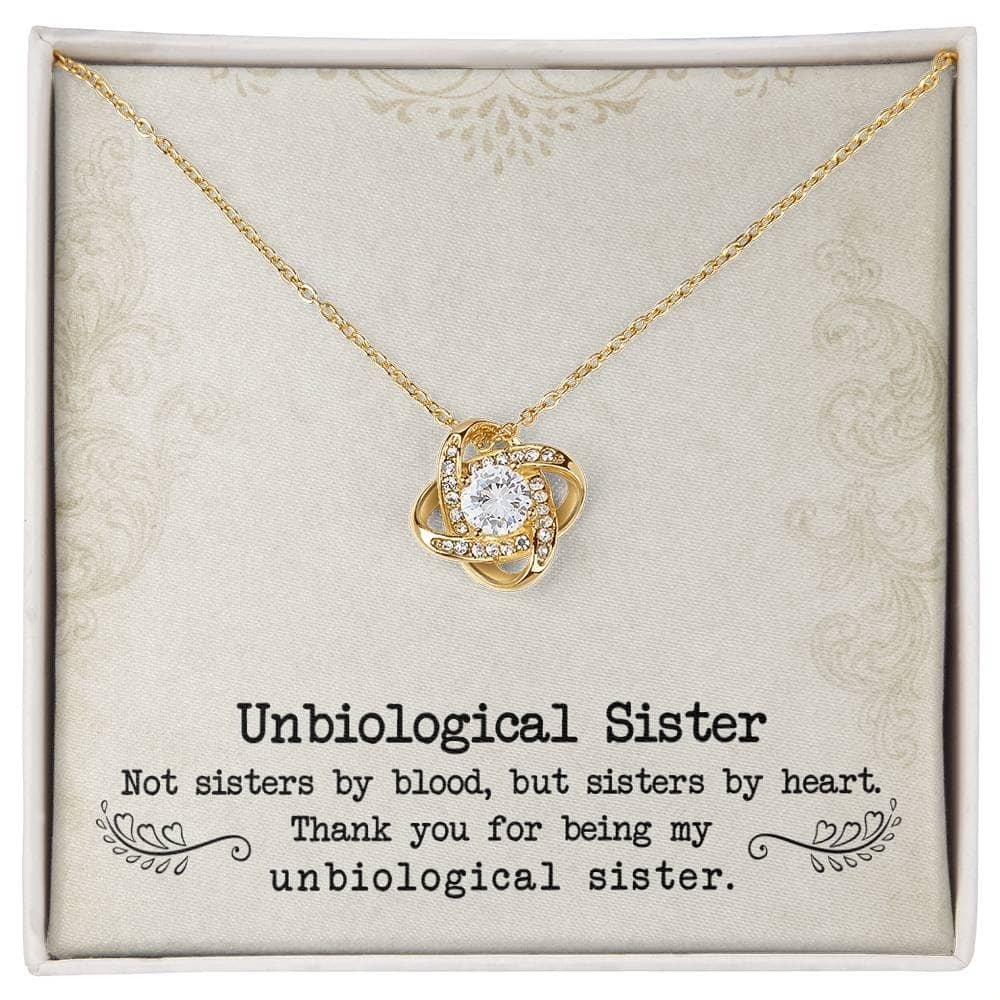 A gold necklace with a diamond pendant in a box, symbolizing the unbreakable bond between unbiological sisters.