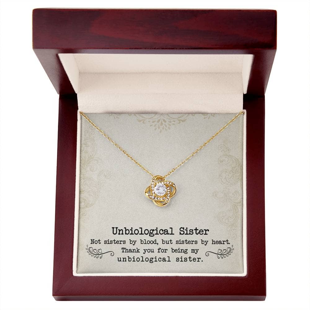 A gold necklace with a diamond pendant, symbolizing the unbiological sister bond, elegantly packaged in a mahogany-style box with LED lighting.