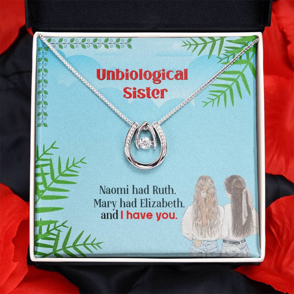 Alt text: "Custom Unbiological Sisters Necklace in a box, featuring interlocking hearts pendant and adjustable chains."