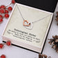 Alt text: "Custom Unbiological Sisters Necklace with Heart Pendant in a box with pine cones and berries"