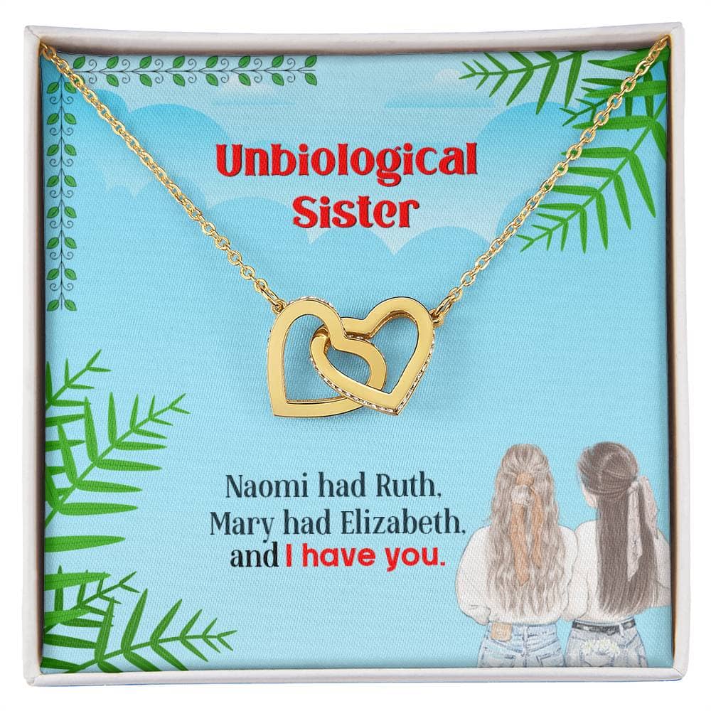 A gold necklace in a box, featuring intertwined hearts, symbolizing the unbreakable bond of unbiological sisters.