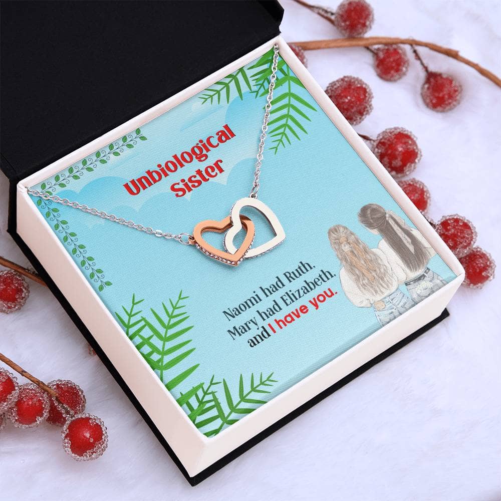 Alt text: Custom Unbiological Sisters Necklace with Interlocking Hearts in a plush mahogany-style box with LED lighting