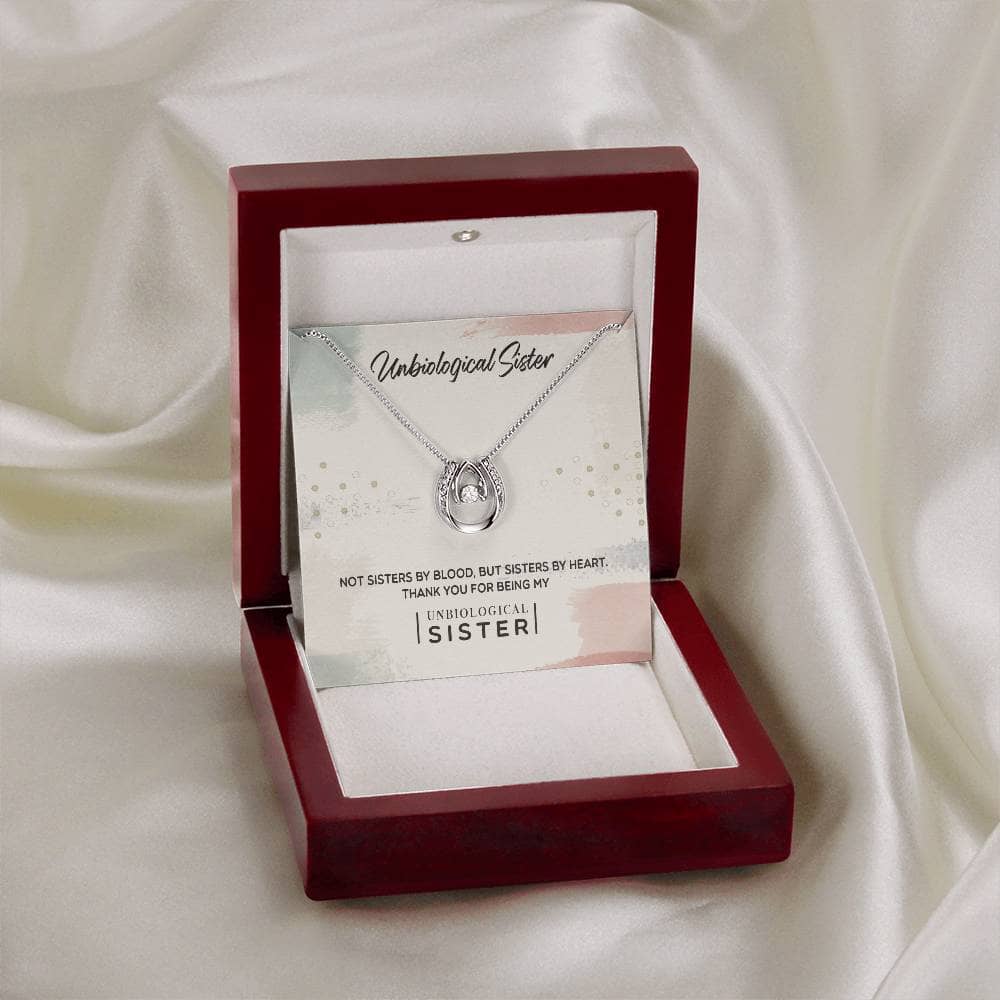 Alt text: "Custom Unbiological Sisters Necklace in a box with diamond pendant"