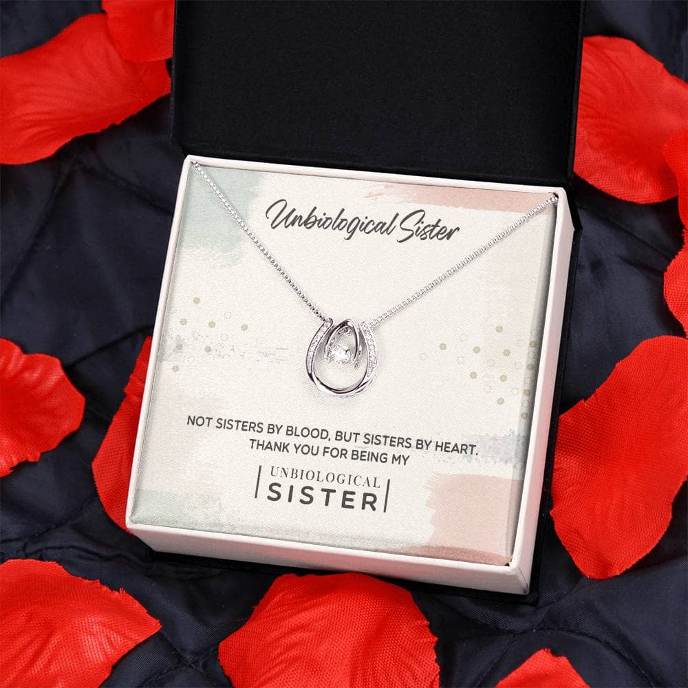 Alt text: "Custom Unbiological Sisters Necklace in LED-lit box, adorned with cubic zirconia pendant symbolizing sisterhood and love. Adjustable chain for perfect fit. Elegant and meaningful gift."