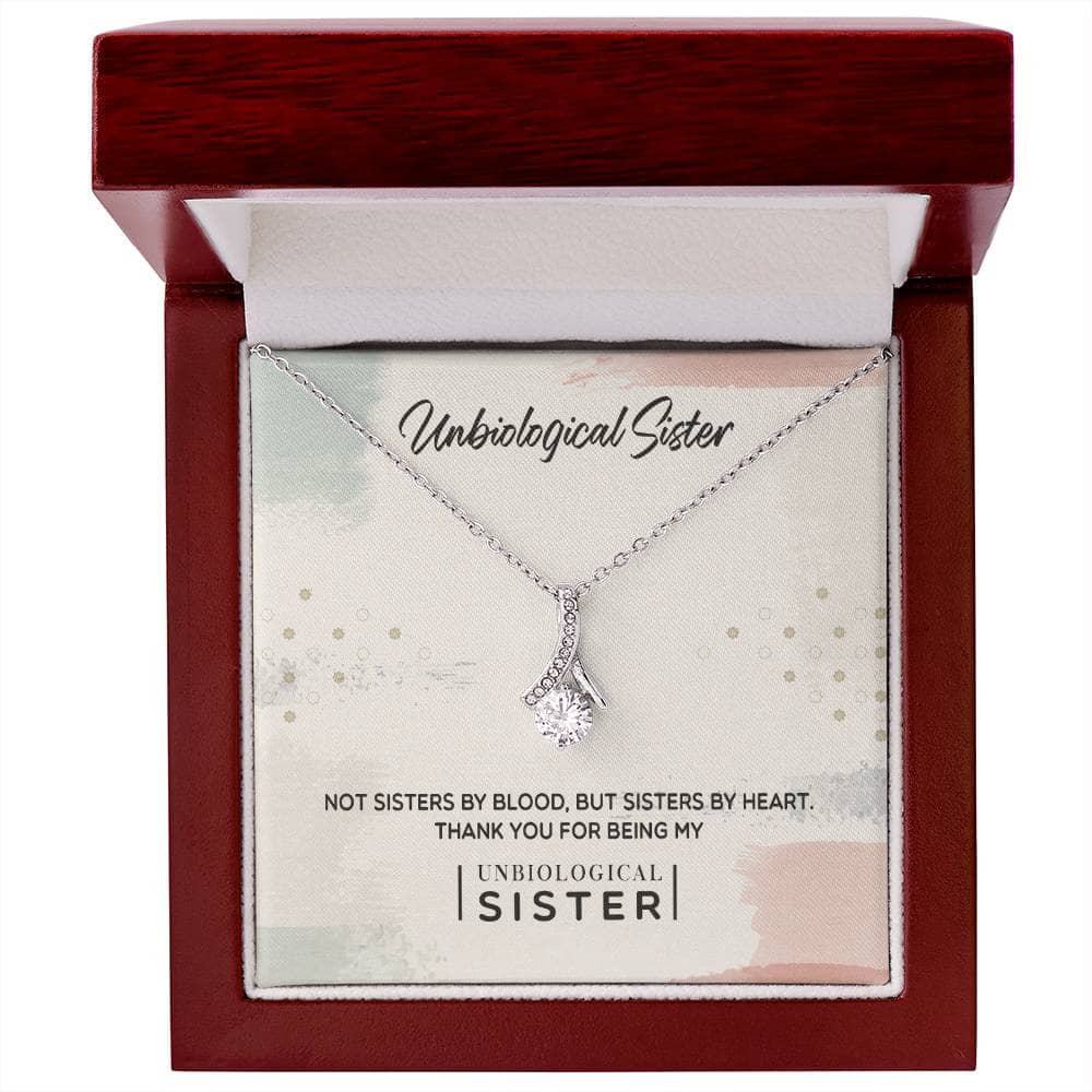 Customizable Unbiological Sisters Love Knot Necklace in a box with LED lighting. Features a diamond pendant in 14k white gold or 18k gold finish.