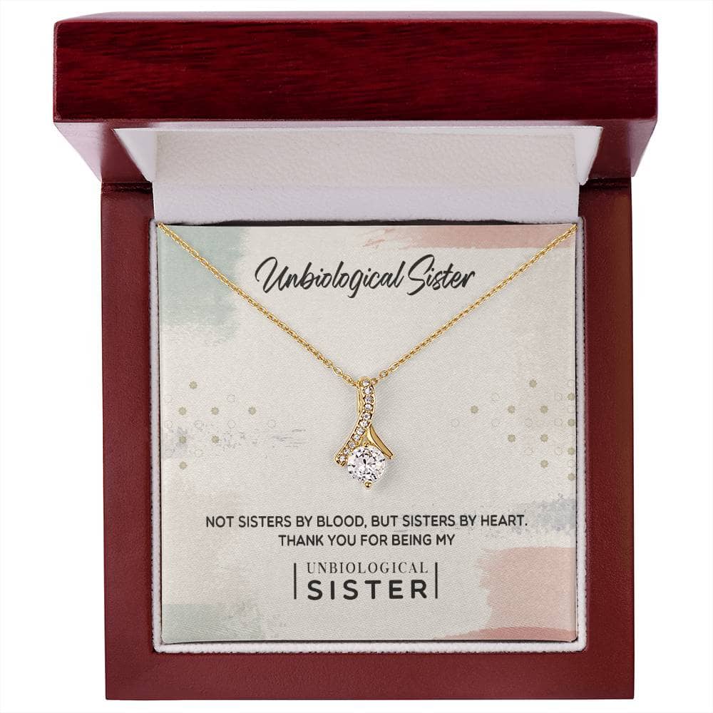 Customizable Unbiological Sisters Love Knot Necklace in a box with a diamond pendant. A symbol of sisterhood and love.