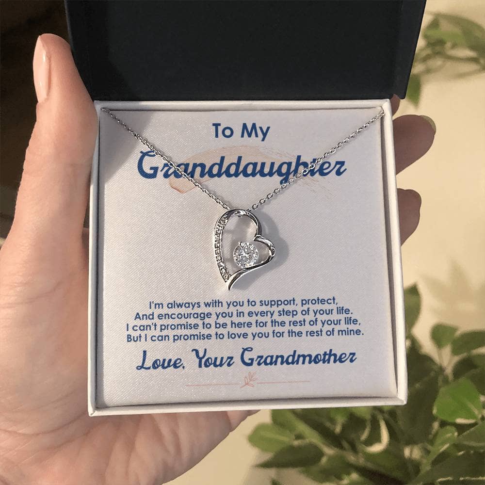 Alt text: "A hand holding a Customized Granddaughter 'Forever Love' Necklace in a mahogany-style box with LED lighting"