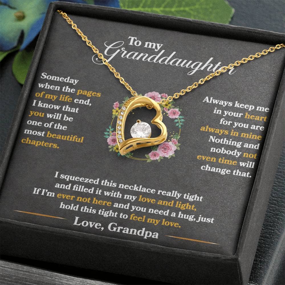 A necklace in a box, featuring a gold heart with a diamond.