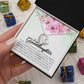 Alt text: "A hand holding a heart-shaped pendant necklace in a luxurious box with LED lighting"
