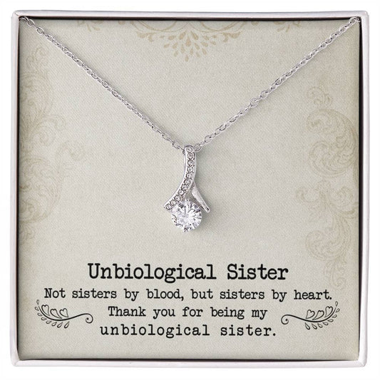 Alt text: "Customized Unbiological Sisters Necklace in a box, featuring a shimmering pendant with a cushion-cut cubic zirconia. Symbolizes enduring sisterly bond."