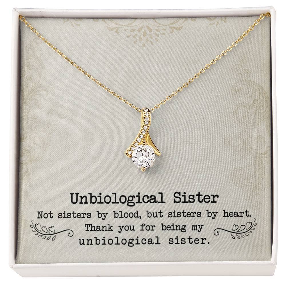 Alt text: "Gold necklace with diamond pendant in box, symbolizing unshakeable bond between unbiological sisters"