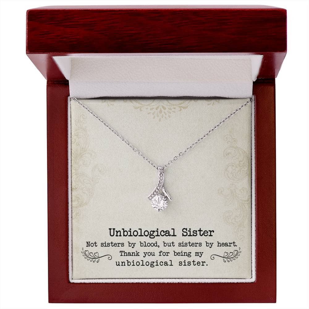 Alt text: "Customized Unbiological Sisters Necklace in a box, symbolizing enduring sisterly bond, with 14k white gold finish and cubic zirconia pendant."