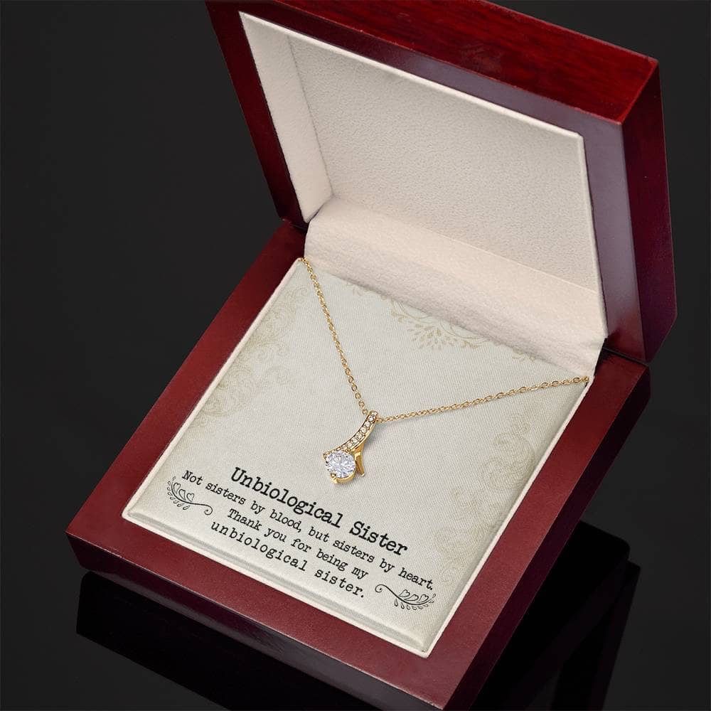 Alt text: "Customized Unbiological Sisters Necklace in gold box with diamond ring pendant"
