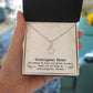 Alt text: "Customized Unbiological Sisters Necklace - A hand holding a necklace in a box, symbolizing the enduring bond between sisters. Shimmering 14k white gold or 18k gold finish with a cushion-cut cubic zirconia at the heart. Timeless accessory for casual and formal wear."