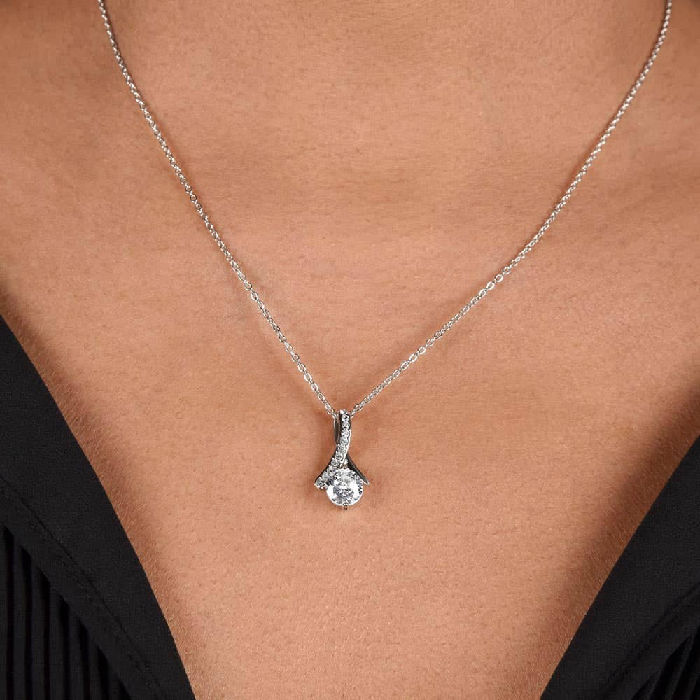 Alt text: "Customized Unbiological Sisters Necklace - Woman wearing a shimmering necklace with a diamond pendant, symbolizing the enduring bond between sisters."