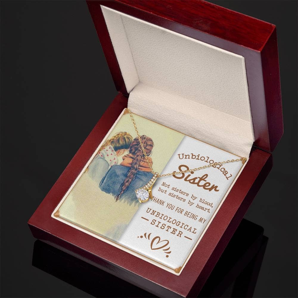 Alt text: "Customized Unbiological Sisters Necklace in a box with a gold necklace and picture of two girls, symbolizing an enduring bond and sentimental connection. Perfect for gifting and celebrating shared memories. 14k white gold or 18k yellow gold finish with a sparkling cubic zirconia."