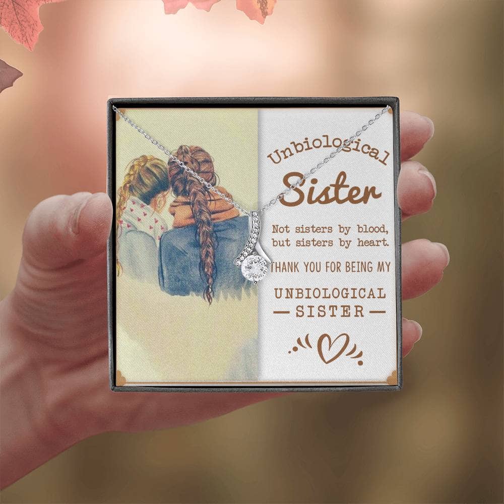 Alt text: "A hand holding a square box with a picture of two girls, showcasing the Customized Unbiological Sisters Alluring Charm Necklace, a symbol of enduring sisterhood and elegance."