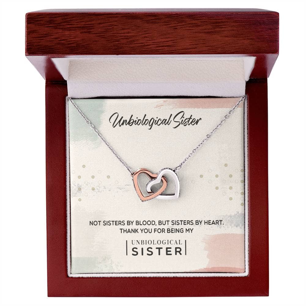 Alt text: "Customized Unbiological Sisters Heart-Link Necklace in a box, featuring interlocking hearts pendant adorned with cubic zirconia."