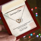 Alt text: Customized Unbiological Sisters Heart-Link Necklace - Hand holding a personalized necklace with interlocking hearts, symbolizing the unbreakable bond between unbiological sisters.